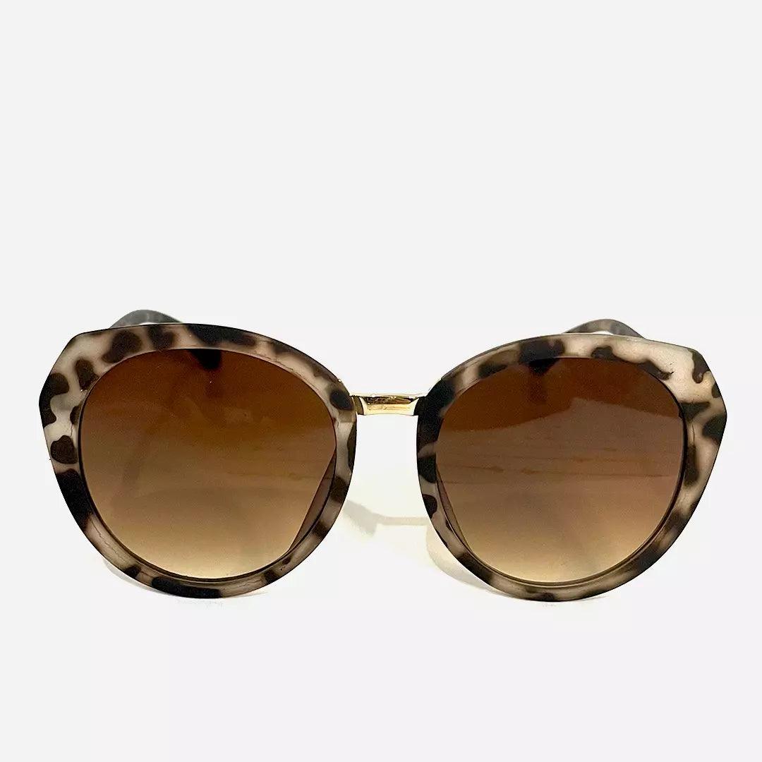 Óculos de sol Ounce com armação estampada em padrão animal print, lentes marrons degradê e design redondo para um visual ousado e sofisticado.