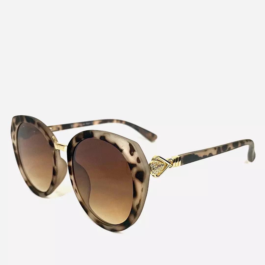 Óculos de sol Ounce com design sofisticado, armação animal print, lentes marrons degradê e detalhes dourados nas hastes, ideal para looks elegantes.